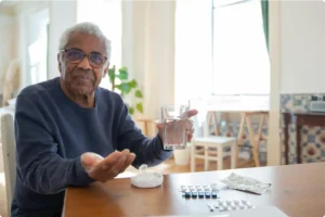 Elderly man managing his chronic medication at home with online doctor support from DirectDoc